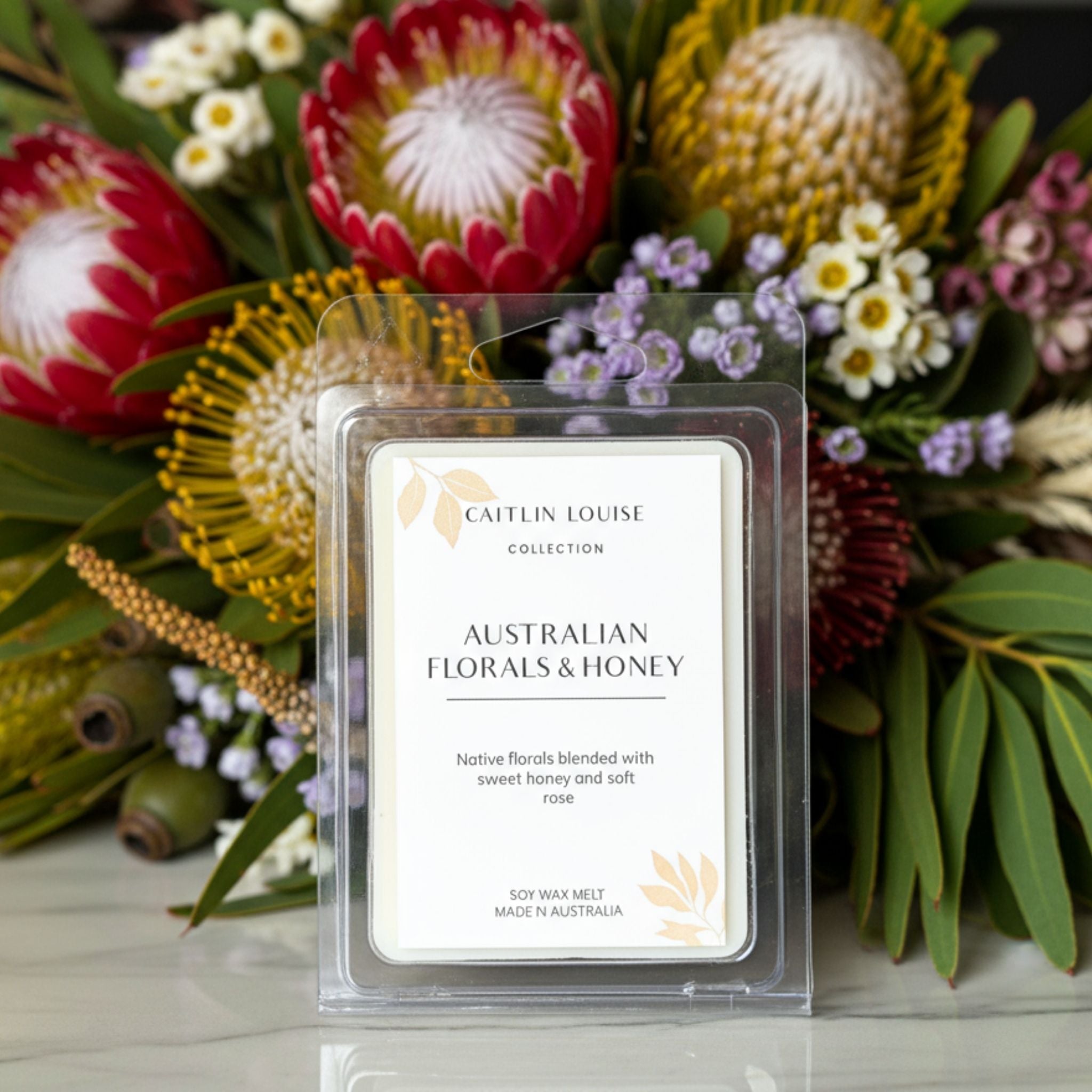 Native florals and honey wax melt with Australian native flowers in background