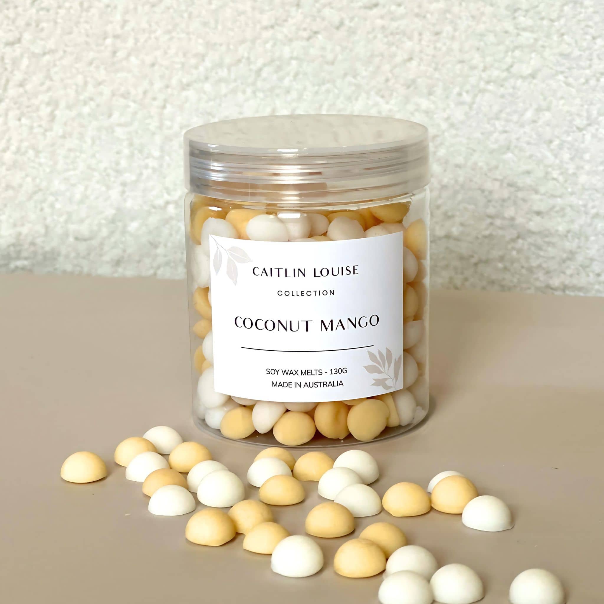 Caitlin Louise Collection's Coconut Mango handcrafted soy wax melt pebbles - white background, tan base.