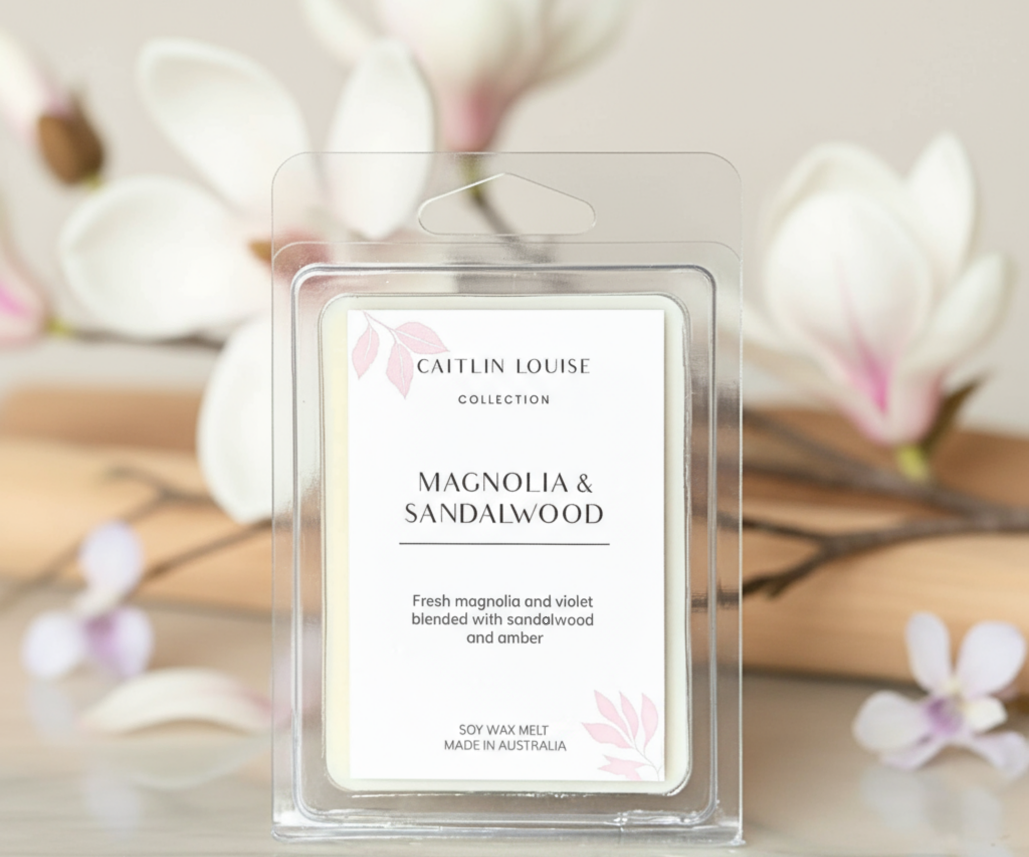 Caitlin Louise Magnolia & Sandalwood wax melt packaging with floral background
