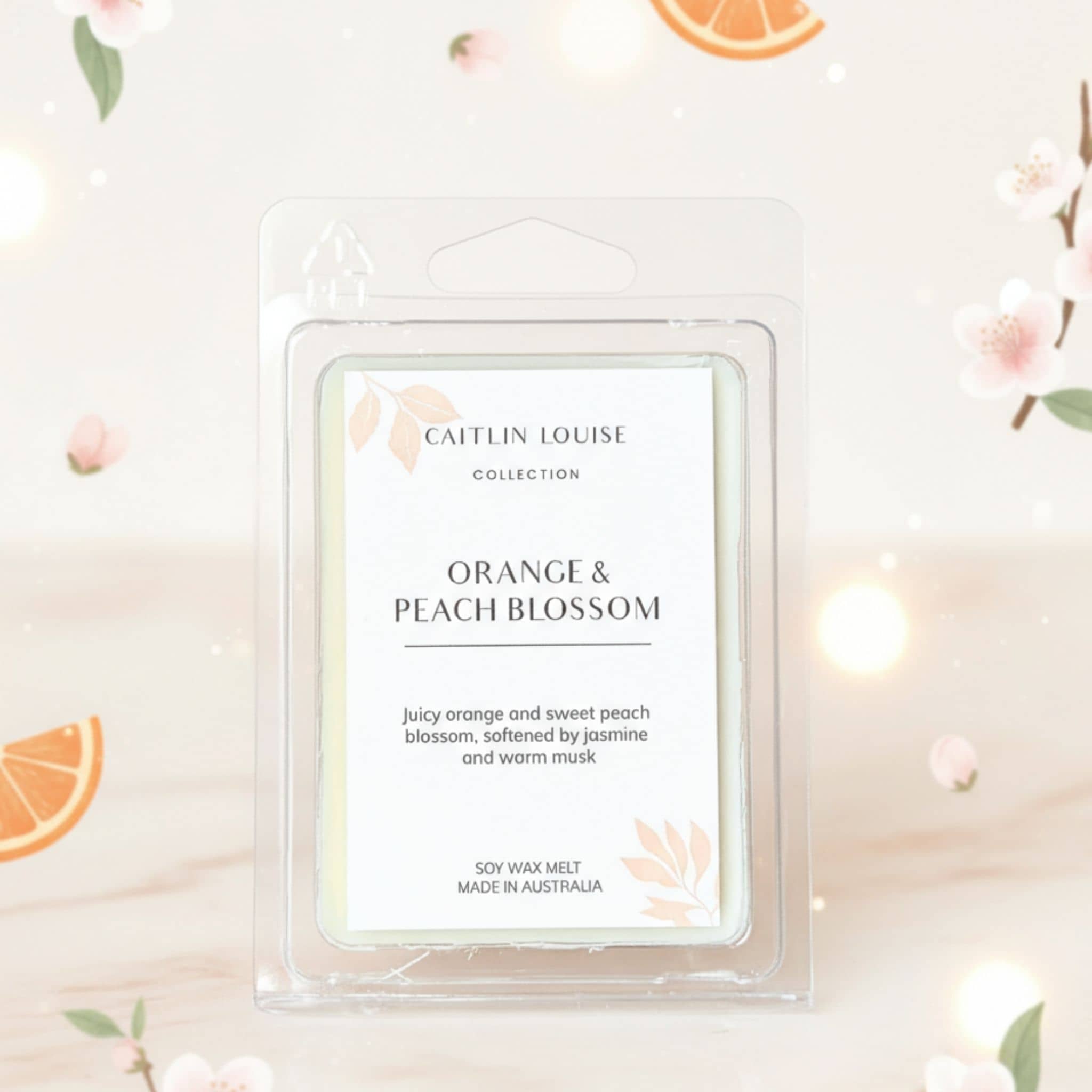 Caitlin Louise Orange & Peach Blossom wax melt packaging on a decorative background with flowers and oranges.