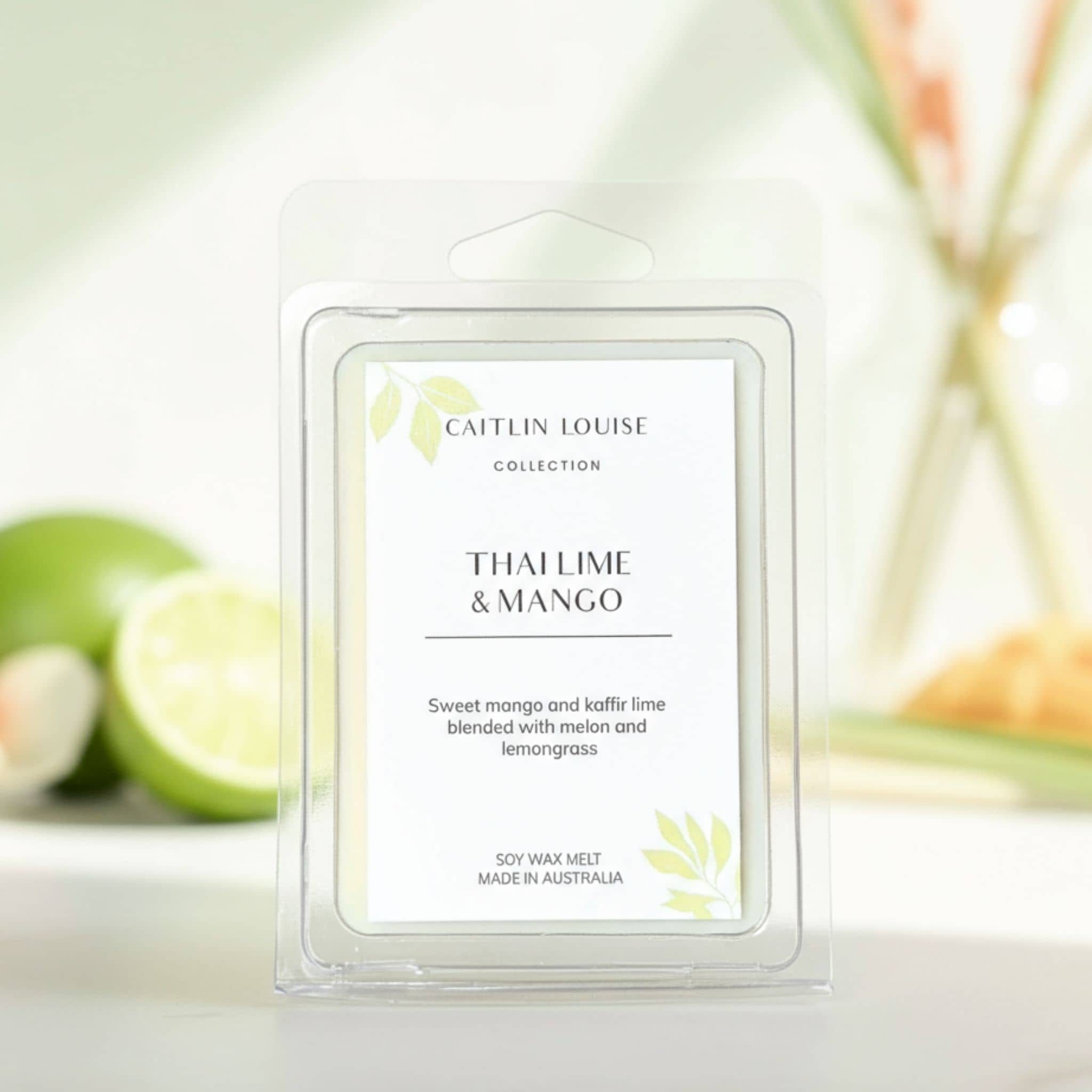 Caitlin Louise Thai Lime & Mango wax melt packaging with limes in the background