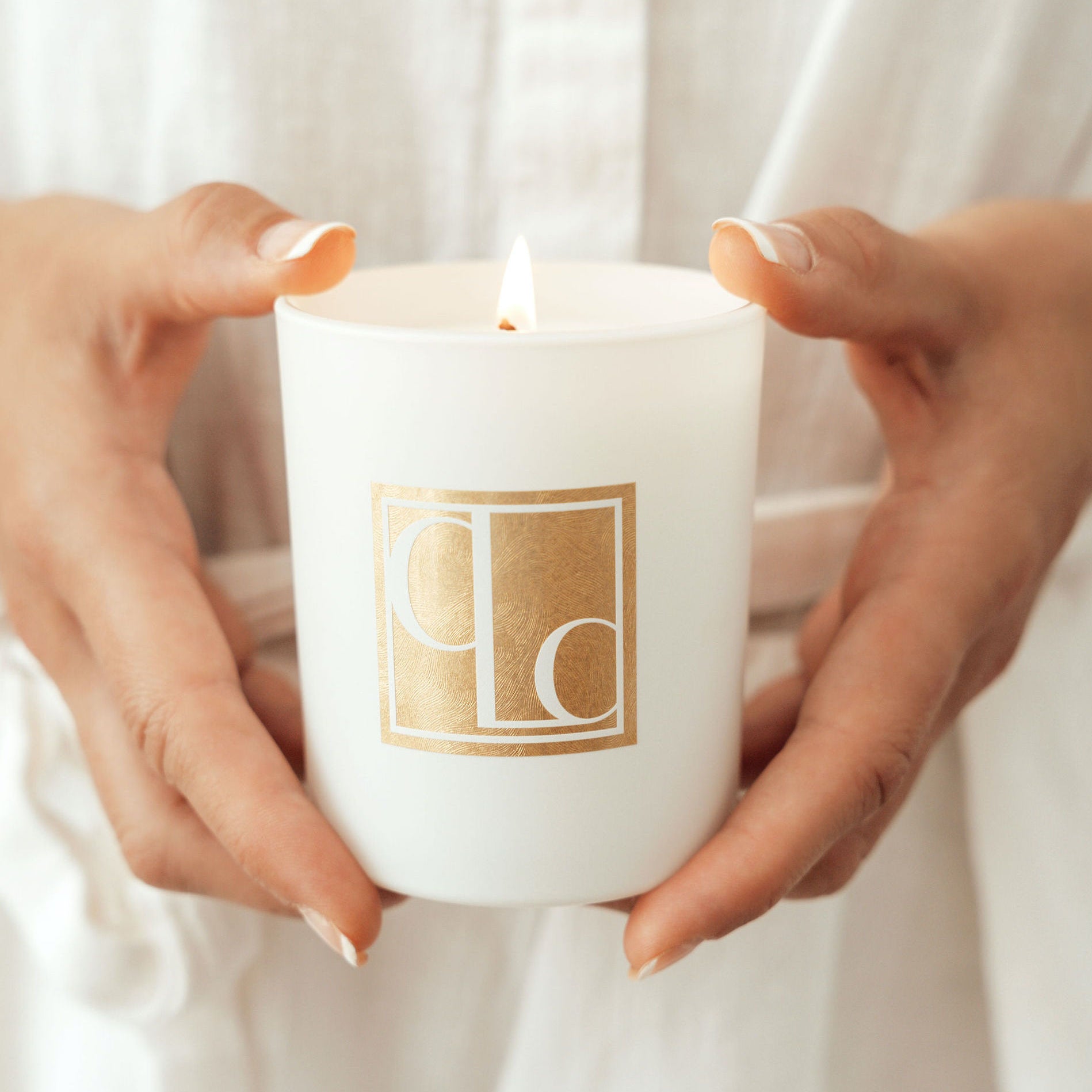 Hands holding Caitlin Louise Collection mini bijou candle