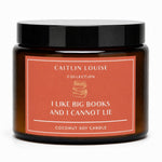 A coconut soy candle in an amber glass jar with a black lid and a terracotta-colored label. The label reads 'CAITLIN LOUISE COLLECTION' and 'I LIKE BIG BOOKS AND I CANNOT LIE'.