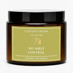 A coconut soy candle in an amber glass jar with a black lid and a muted olive-green label reading 'CAITLIN LOUISE COLLECTION NO SHELF CONTROL'.