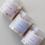 Flat lay of Caitlin Louise Collection's range of luxury bath salts. Showing Me Time, Unwind and Sleep on neutral background.