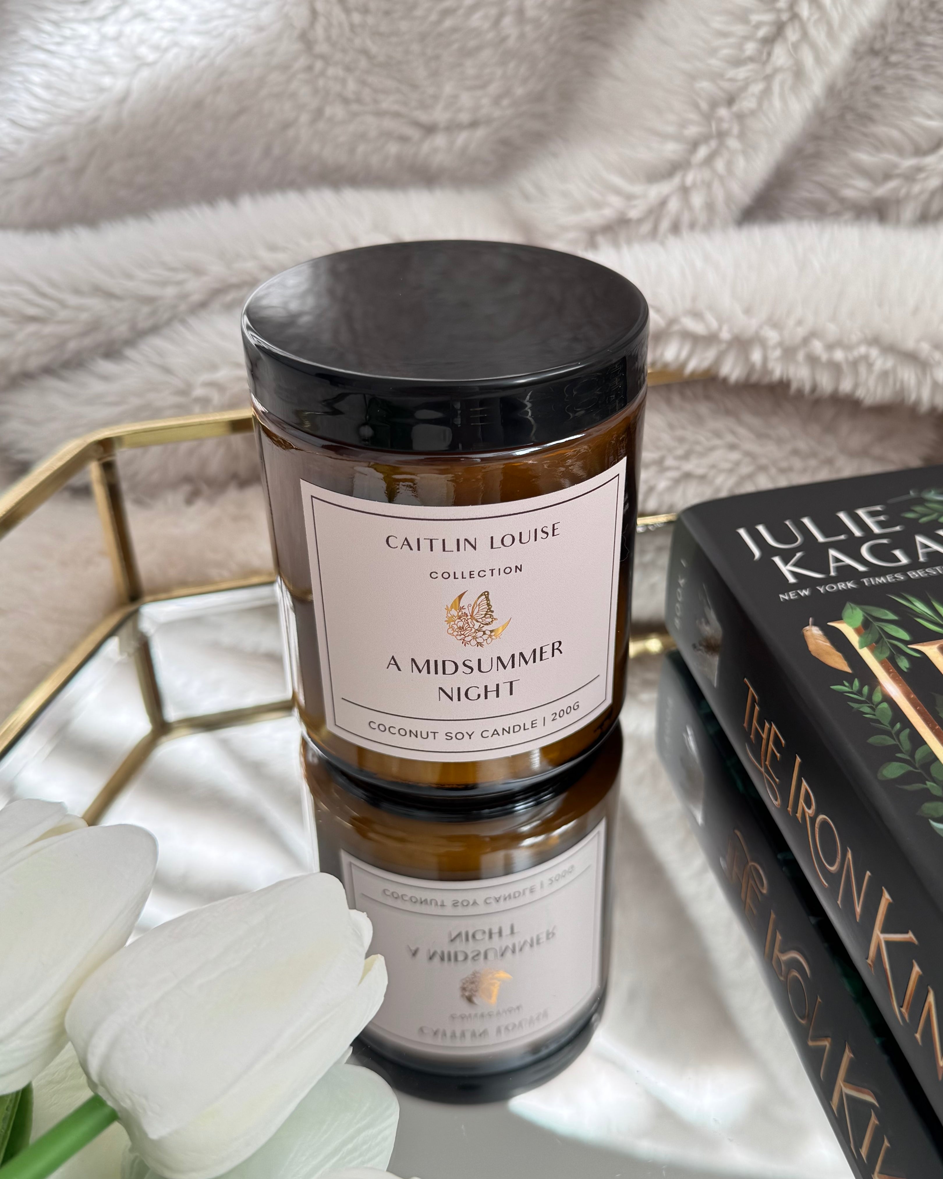 A Midsummer Night Bookish Scented Candle - styled on tray with book and flowers