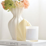 Palm leaf shaped pillar candle styled with flowers and candle