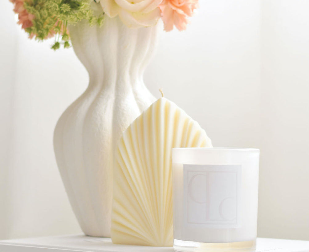 Palm leaf shaped pillar candle styled with flowers and candle