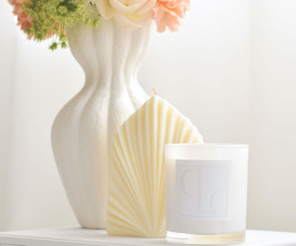 Palm leaf shaped pillar candle styled with flowers and candle