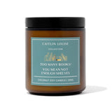 Candle with a label by Caitlin Louise Collection on a white background