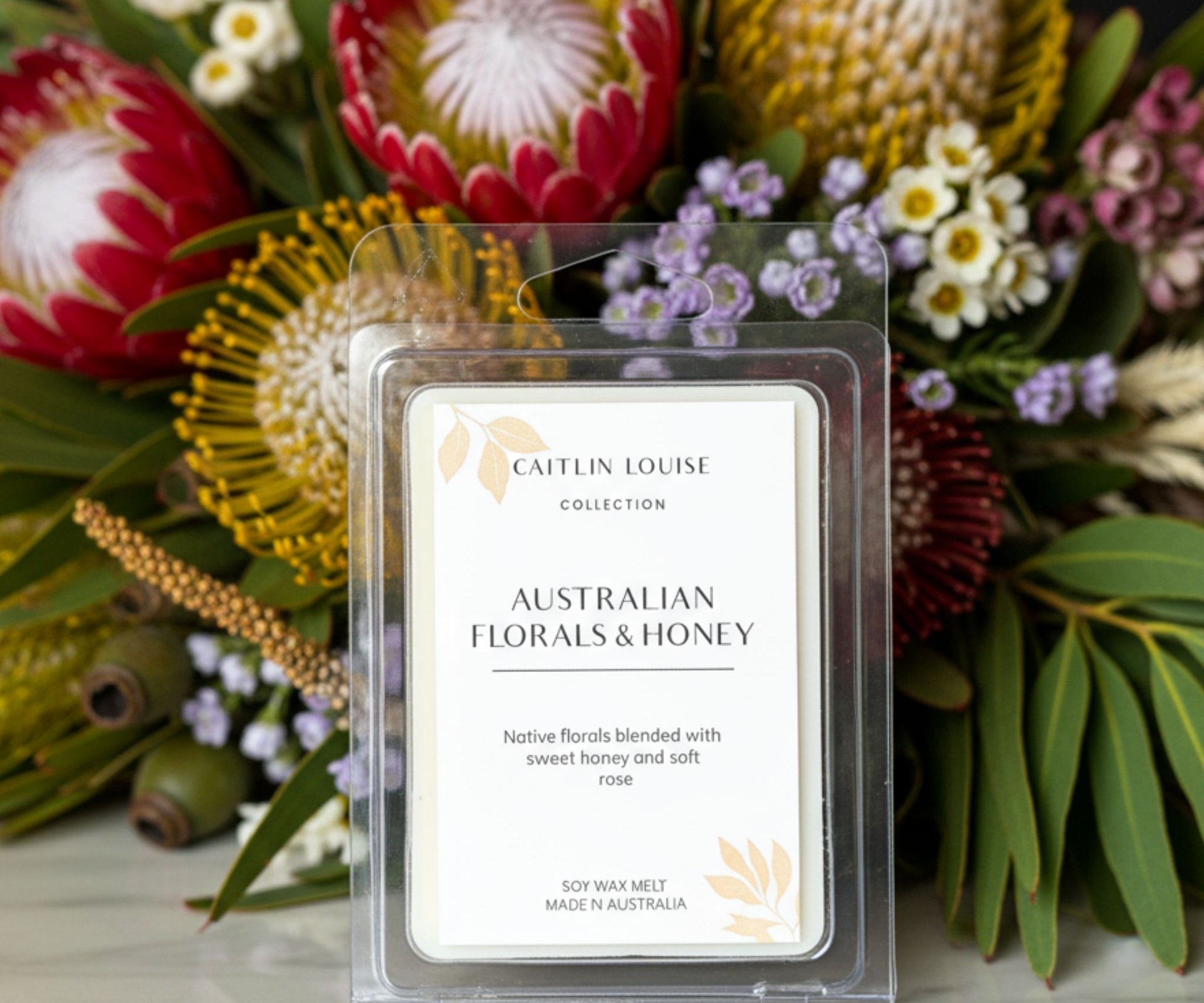 Native florals and honey wax melt with Australian native flowers in background