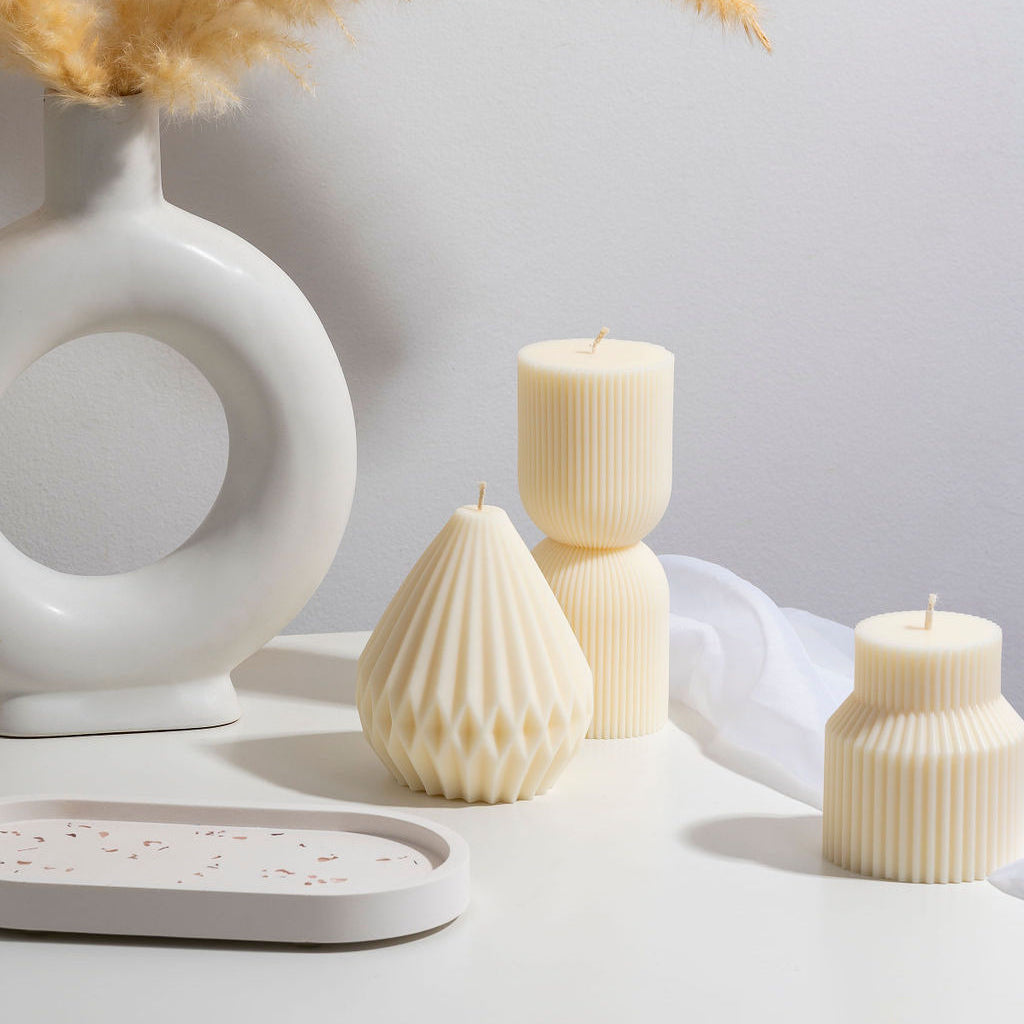 Styled sculptural candles with white background, candle tray and vase