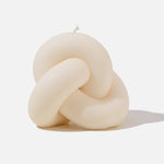 White knot shaped candle - white background