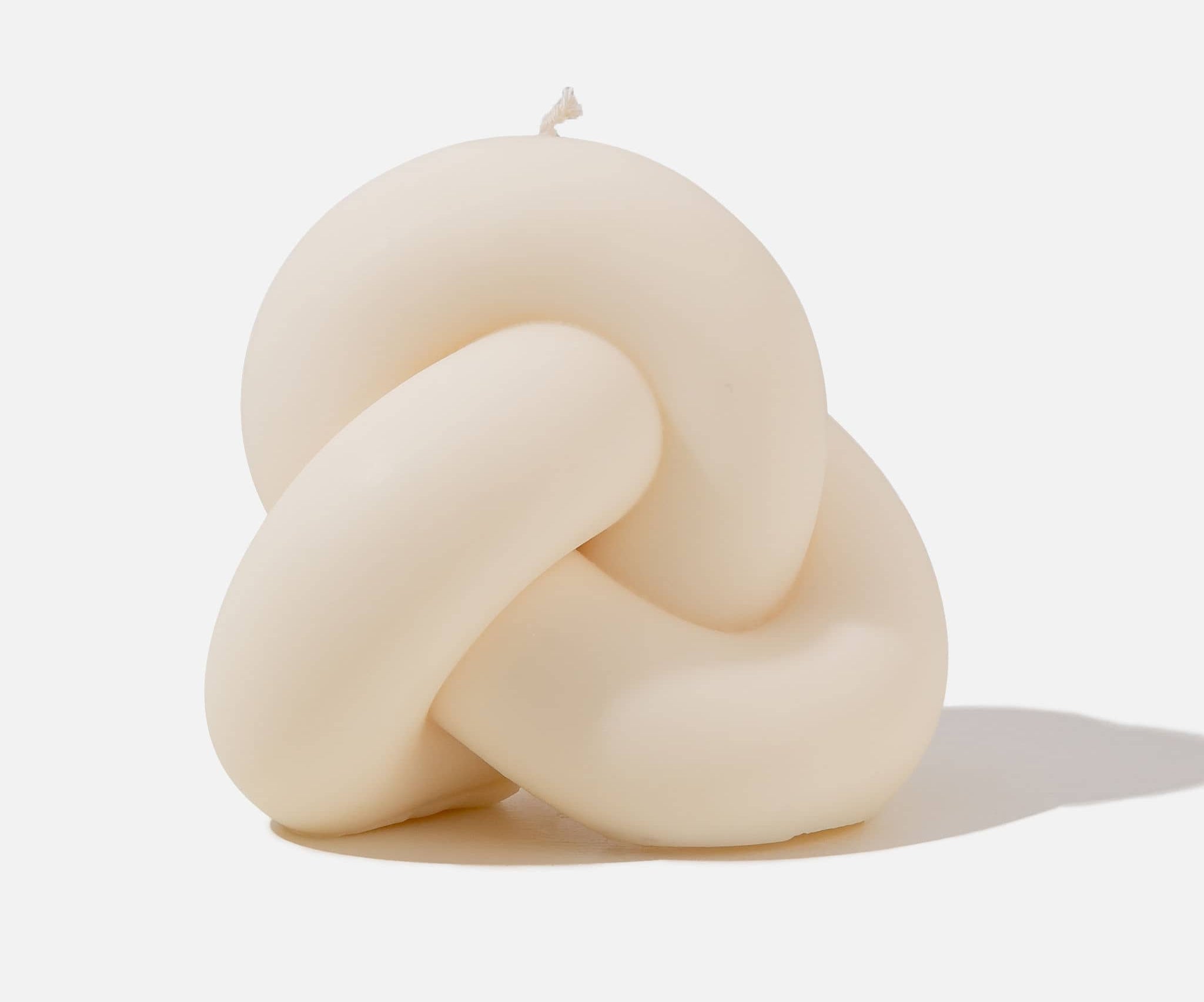 White knot shaped candle - white background