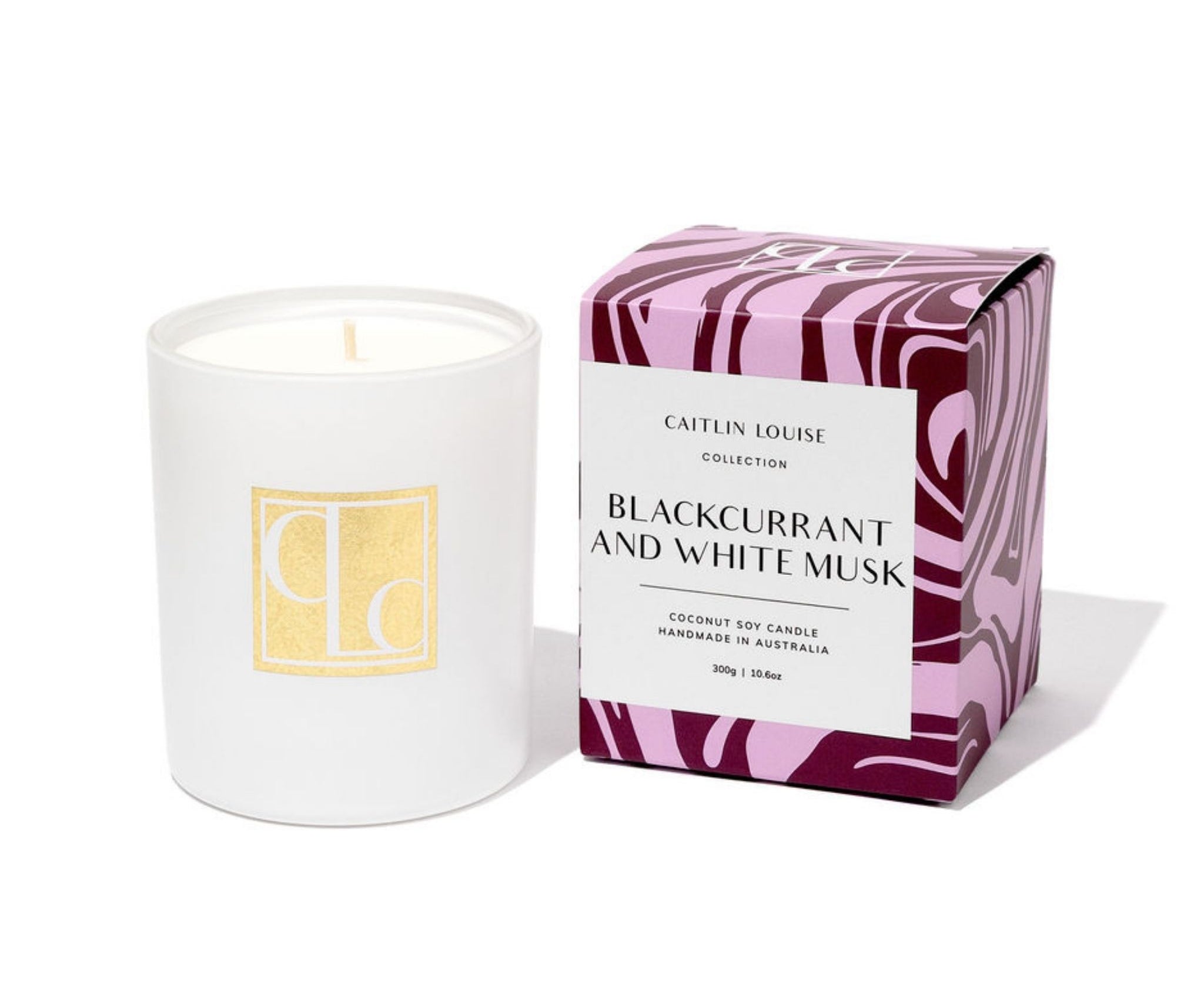 Caitlin Louise Collection candle with a light purple and maroon patterned box labeled 'Blackcurrant and White Musk' on a white background.
