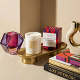Candle with a decorative box and books on a table
