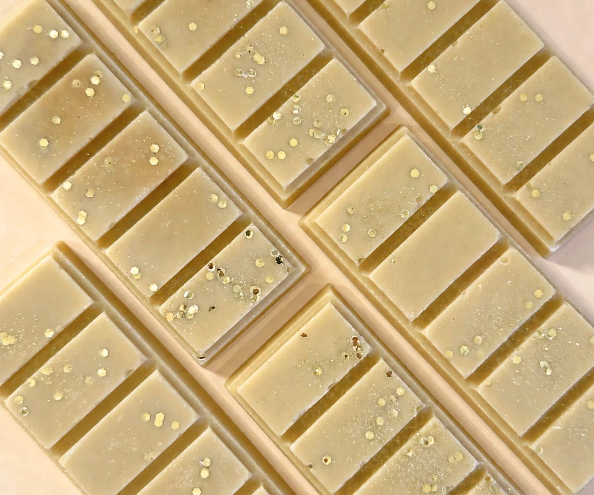 Caramel popcorn scented wax melt snap bars flat lay on apricot coloured background