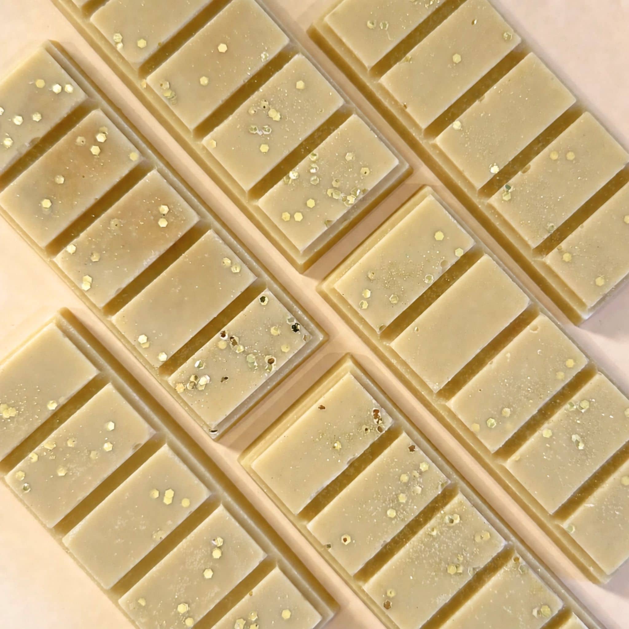 Caramel popcorn scented wax melt snap bars flat lay on apricot coloured background