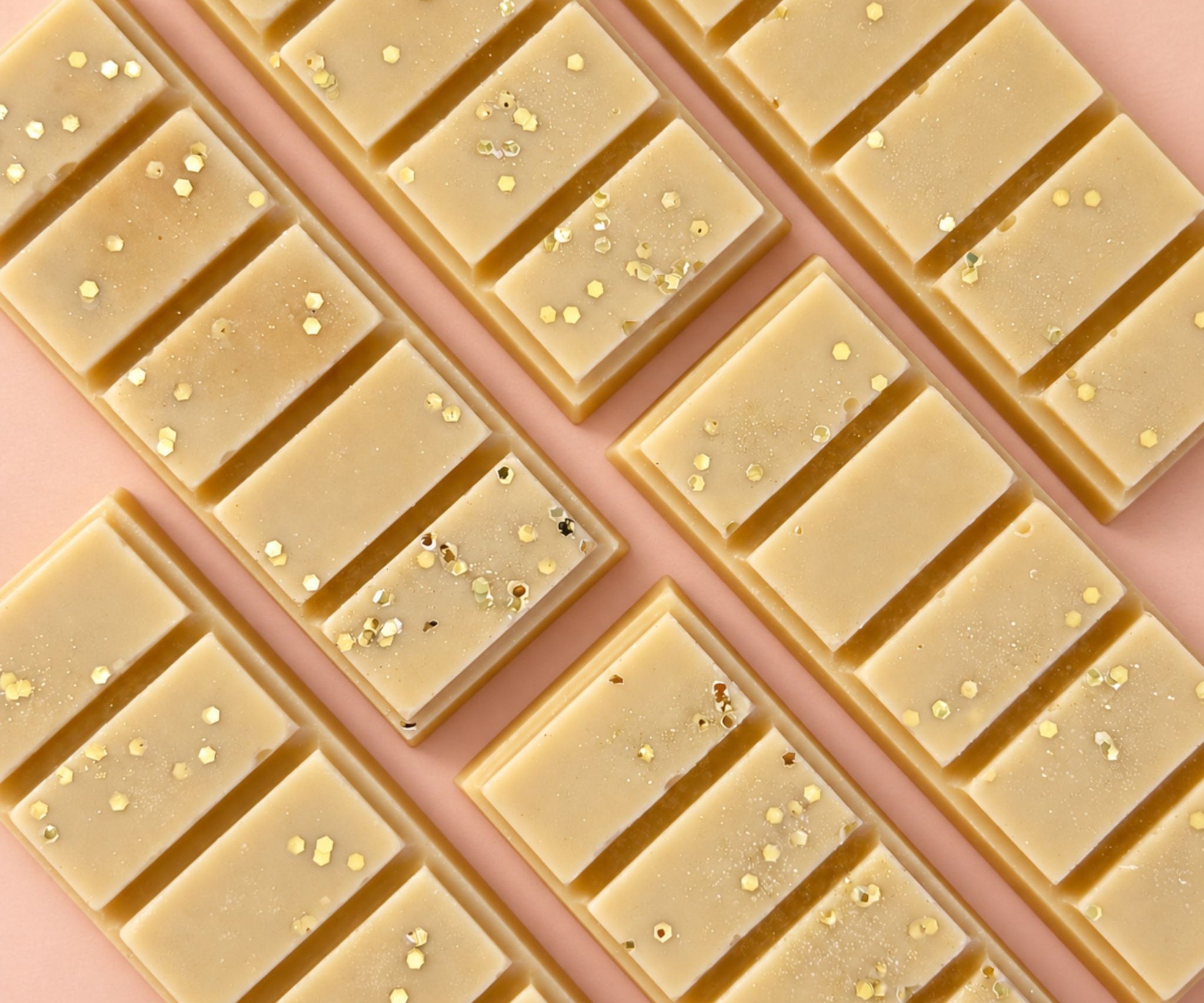 Caramel popcorn scented wax melt - flat lay on rose coloured background