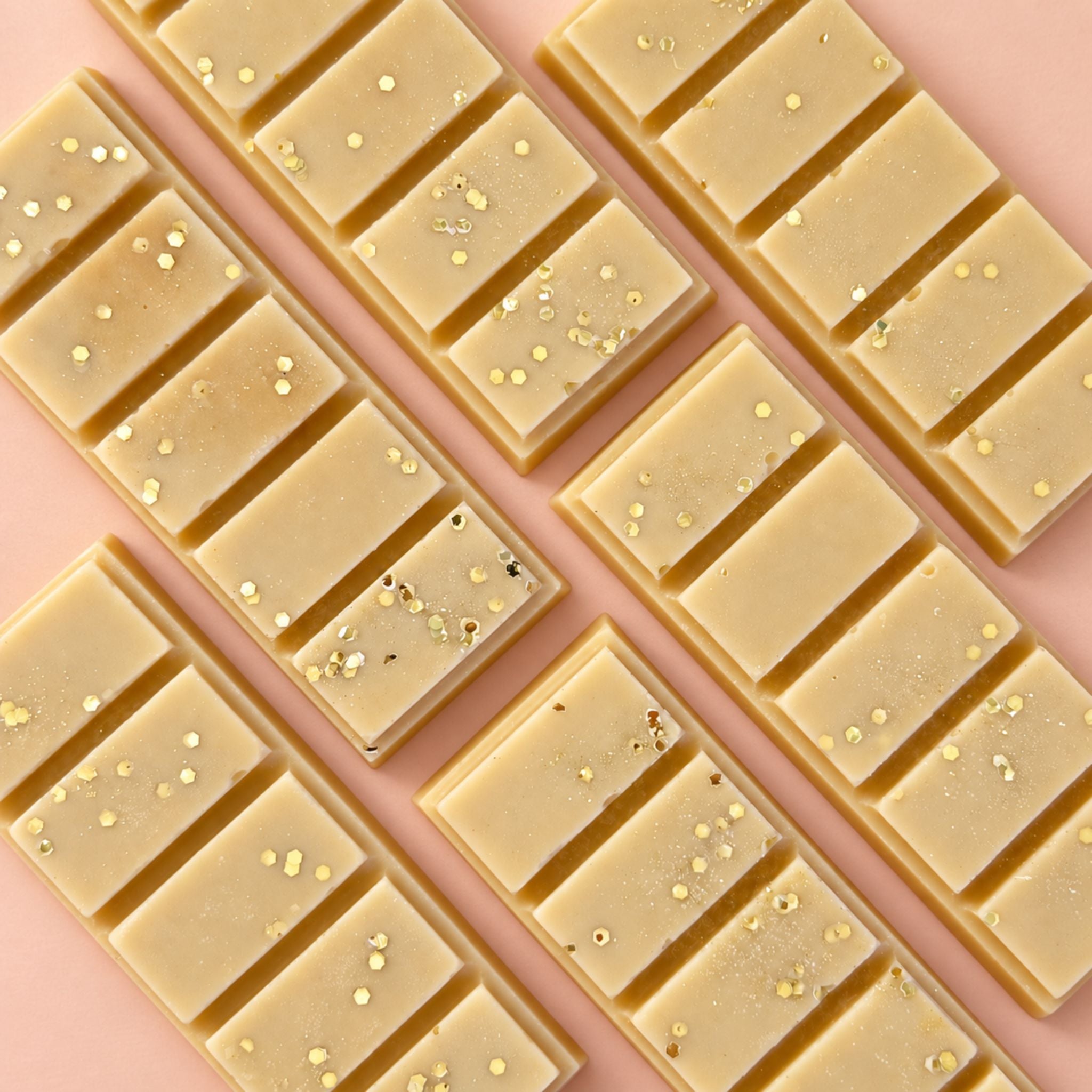 Caramel popcorn scented wax melt - flat lay on rose coloured background