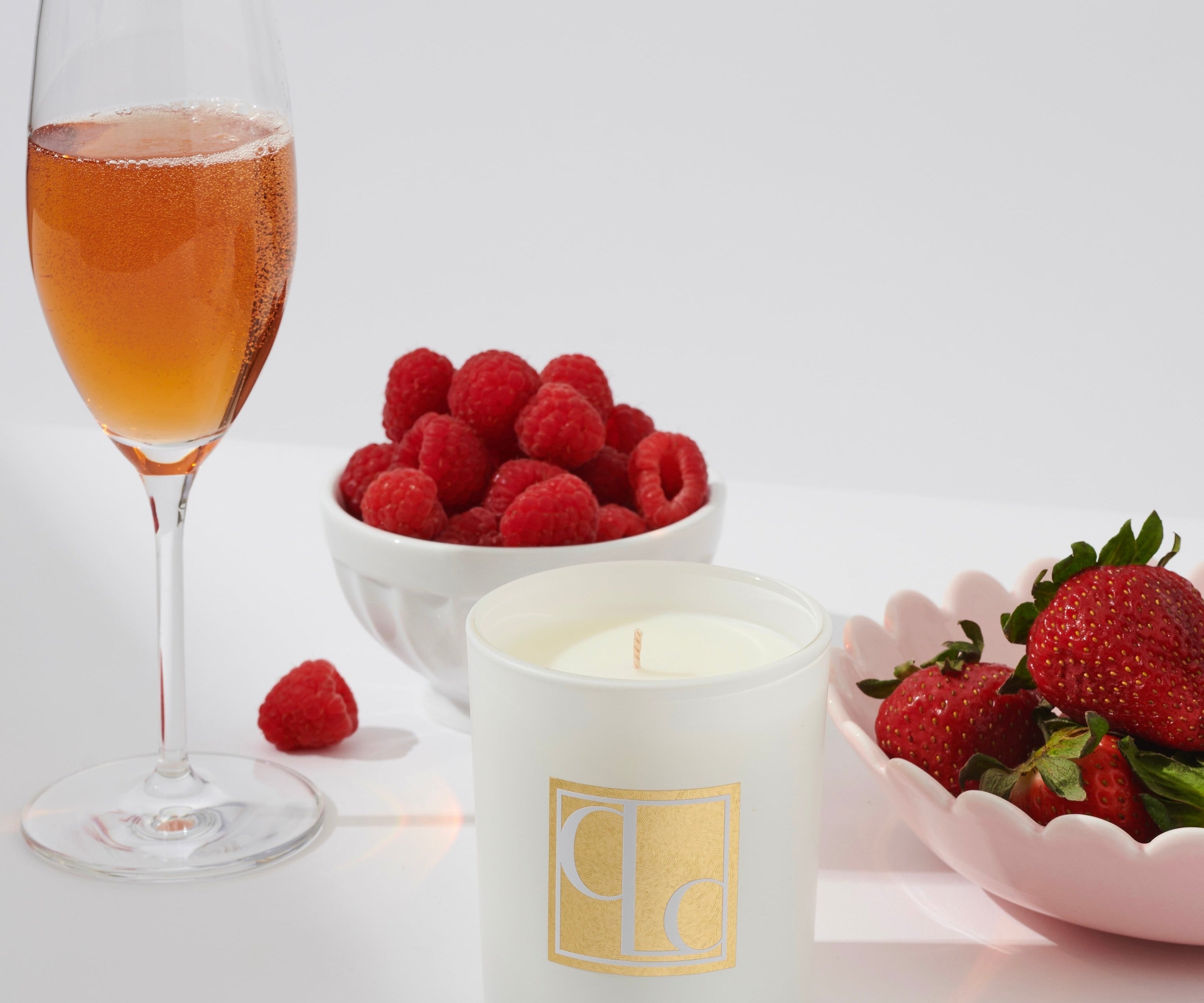 Champagne and strawberries candle styled with champagne, strawberries and raspberries