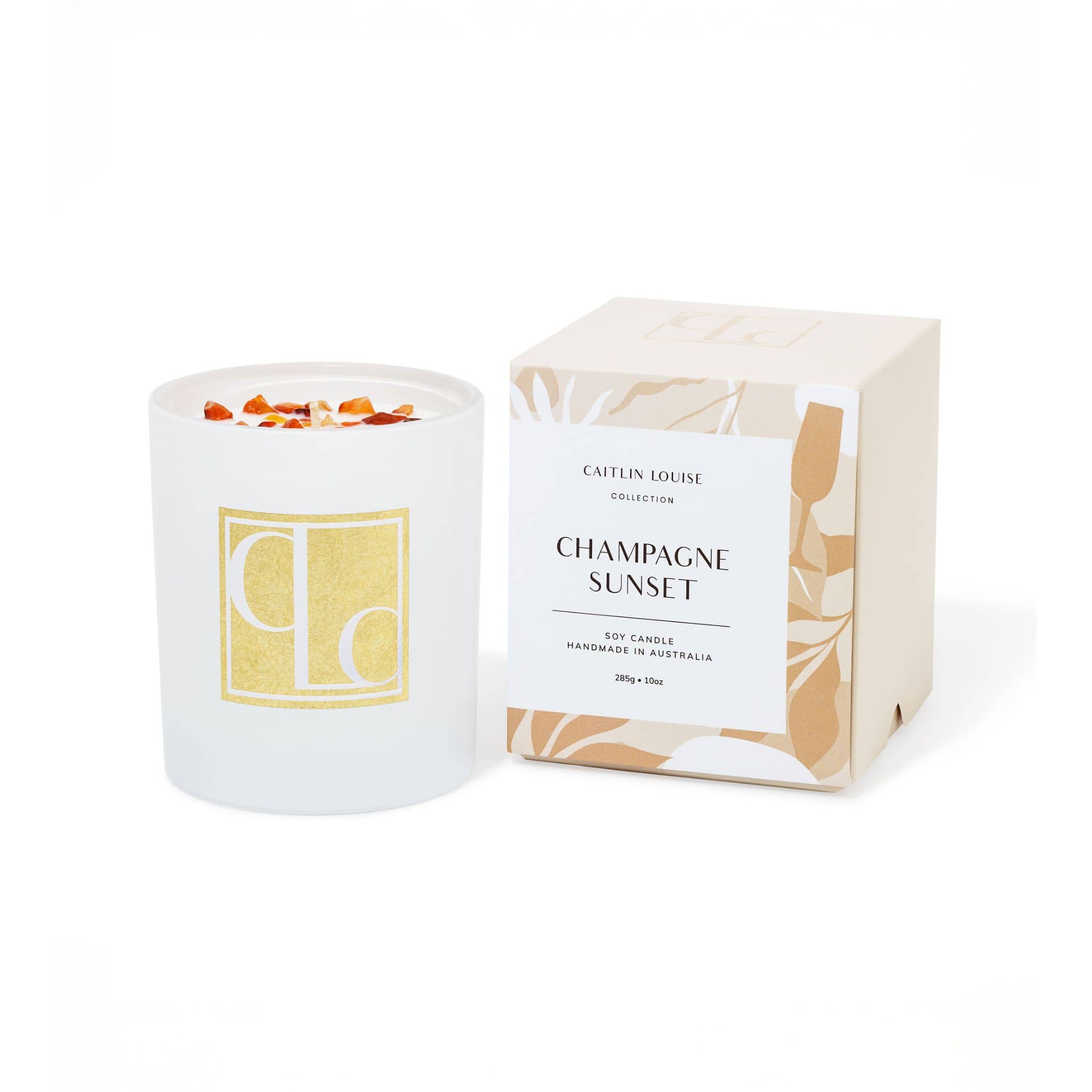 Crystal infused soy Candle with decorative packaging labeled 'Champagne Sunset' on a white background