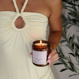 Person holding a lit candle labeled 'Fake Dating Energy' with a plant in the background