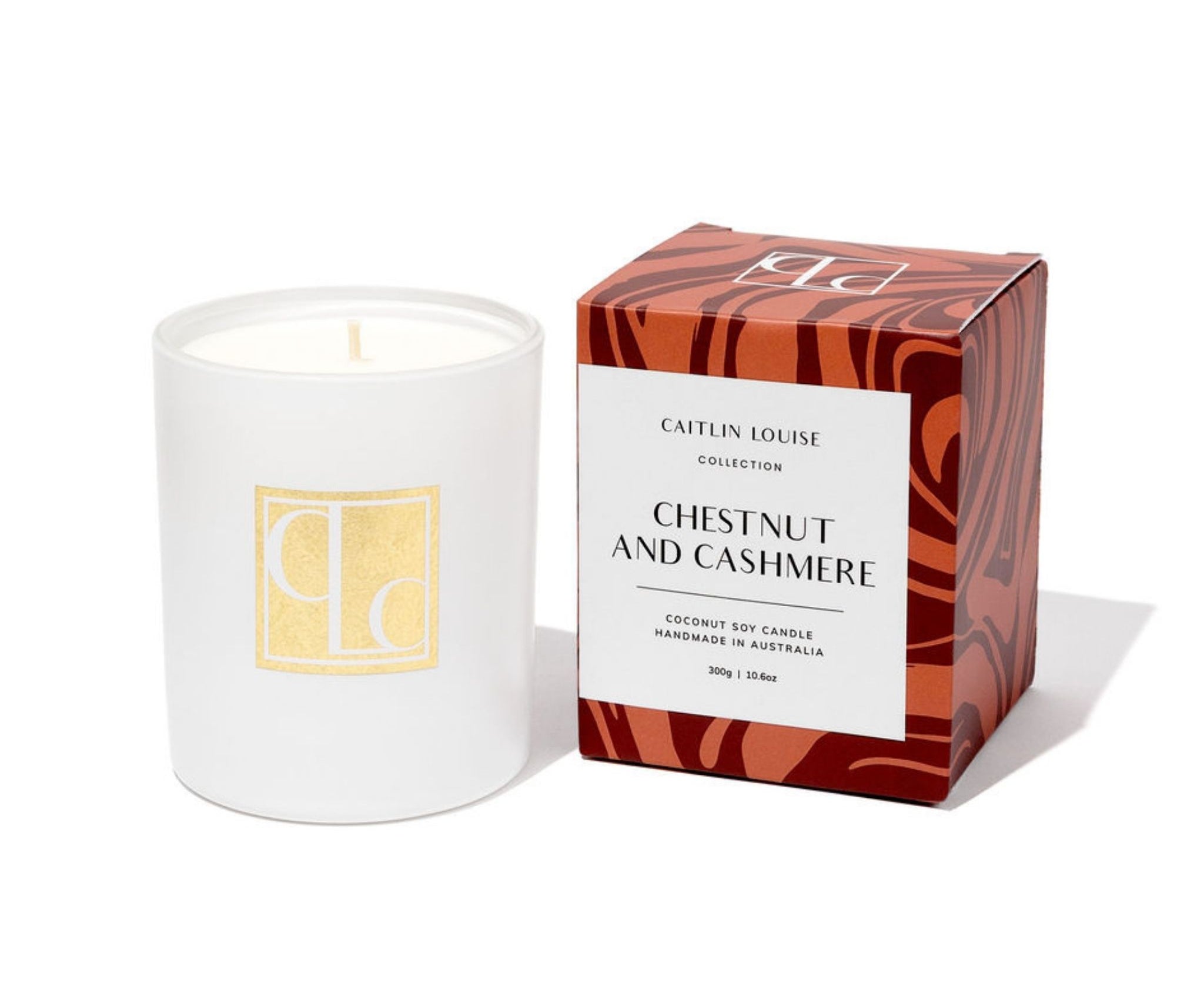 Candle with packaging labeled 'Caitlin Louise Collection Chestnut and Cashmere' on a white background