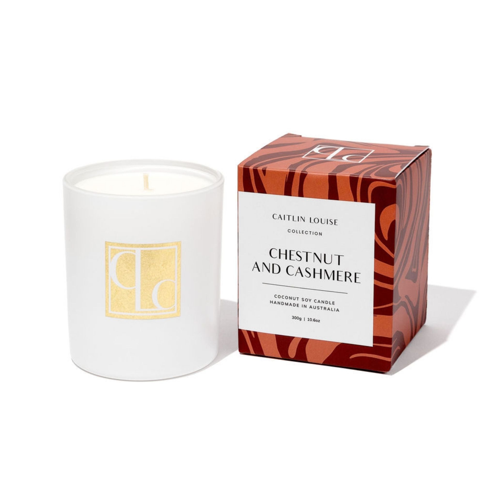 Candle with packaging labeled 'Caitlin Louise Collection Chestnut and Cashmere' on a white background