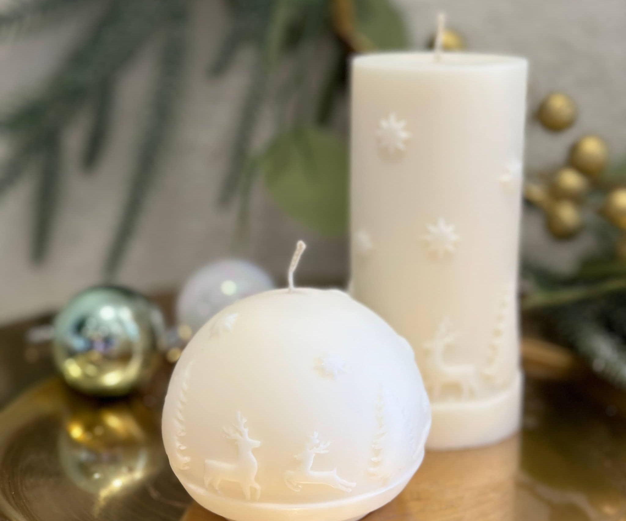 Caitlin Louise Collection Reindeer Sphere Sculptural Candle and Reindeer Large Pillar Candle - on gold tray - wreath in background