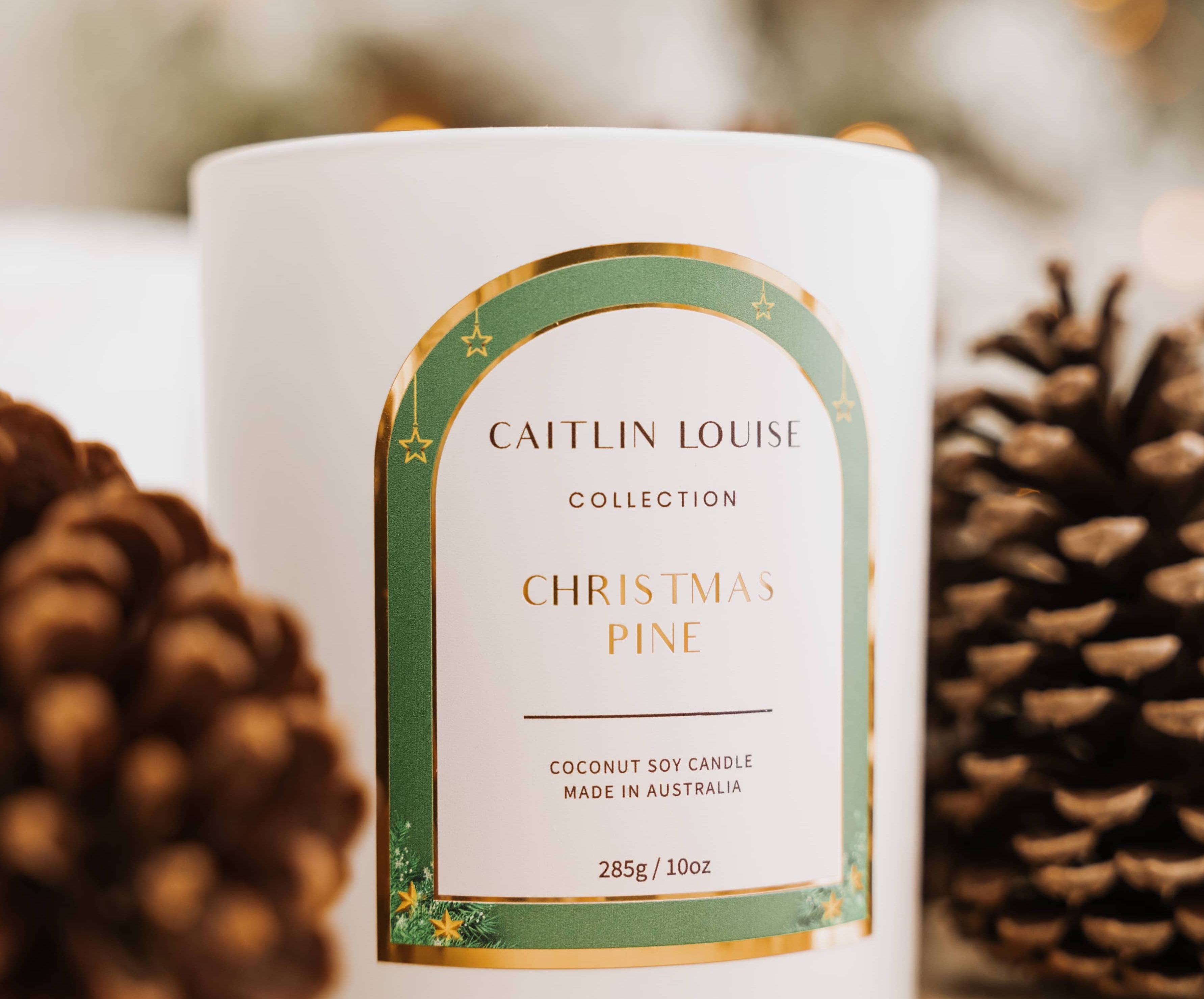 Caitlin Louise Collection Christmas Pine scented candle styled with pine cones