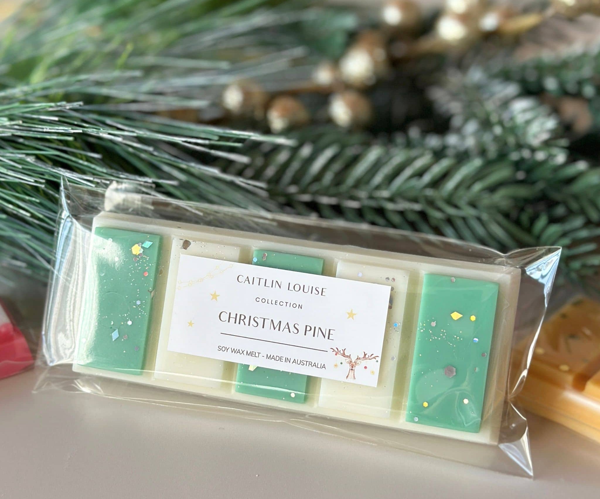 Caitlin Louise Collection Christmas Pine Soy Wax Melt in packaging - styled with wreath