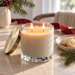 Caitlin Louise Collection Christmas Shortbread scented candle on stone table with pine sprigs and shortbread on the table