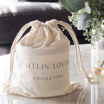 Caitlin Louise Collection Christmas Shortbread scented candle in branded canvas bag on coffee table