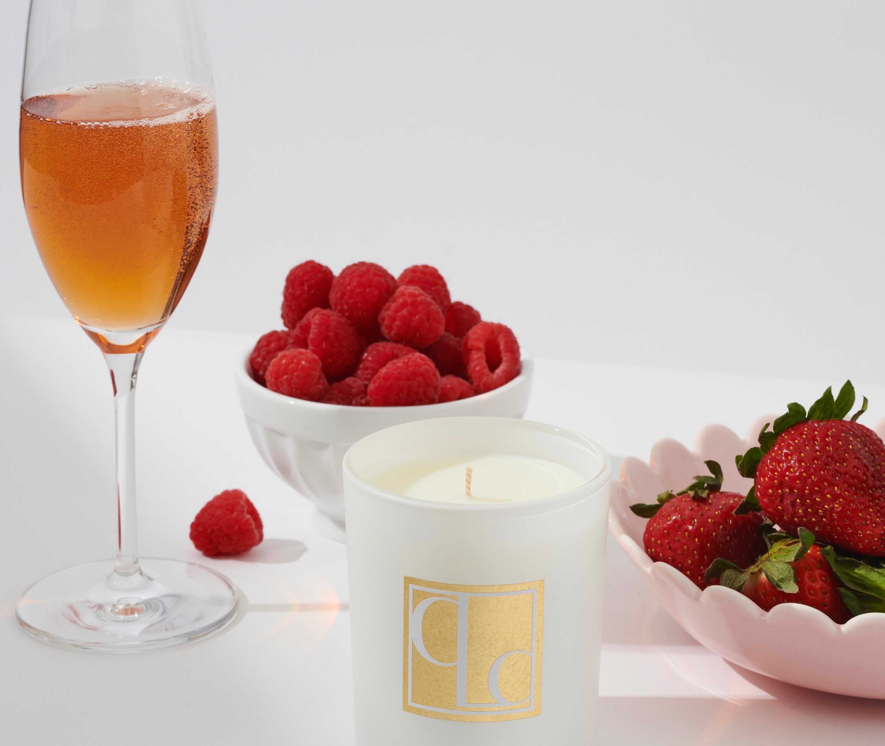 Champagne and strawberries candle styled with champagne, strawberries and raspberries