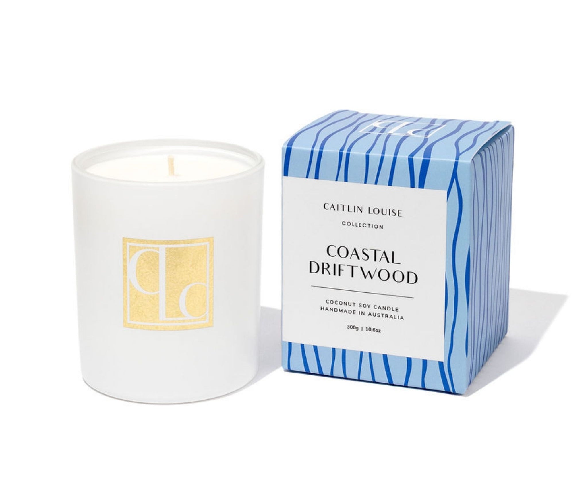 Caitlin Louise Collection candle with a box labeled 'Coastal Driftwood' on a white background