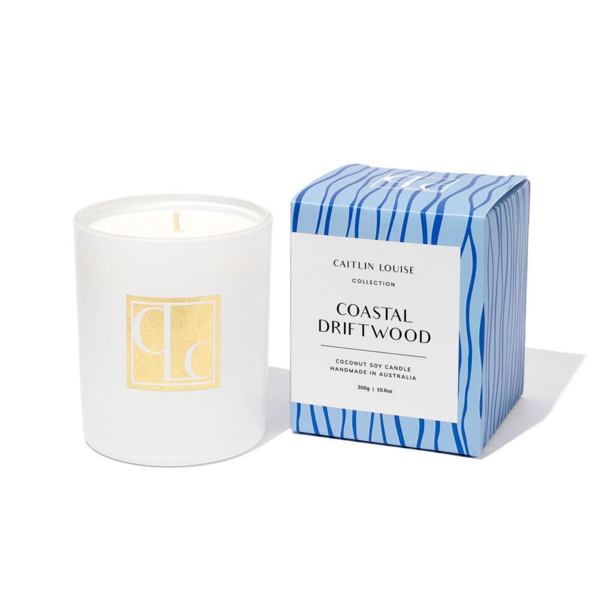 Caitlin Louise Collection candle with a box labeled 'Coastal Driftwood' on a white background