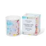 Caitlin Louise Collection Candle with beach-themed artwork and matching box on a white background
