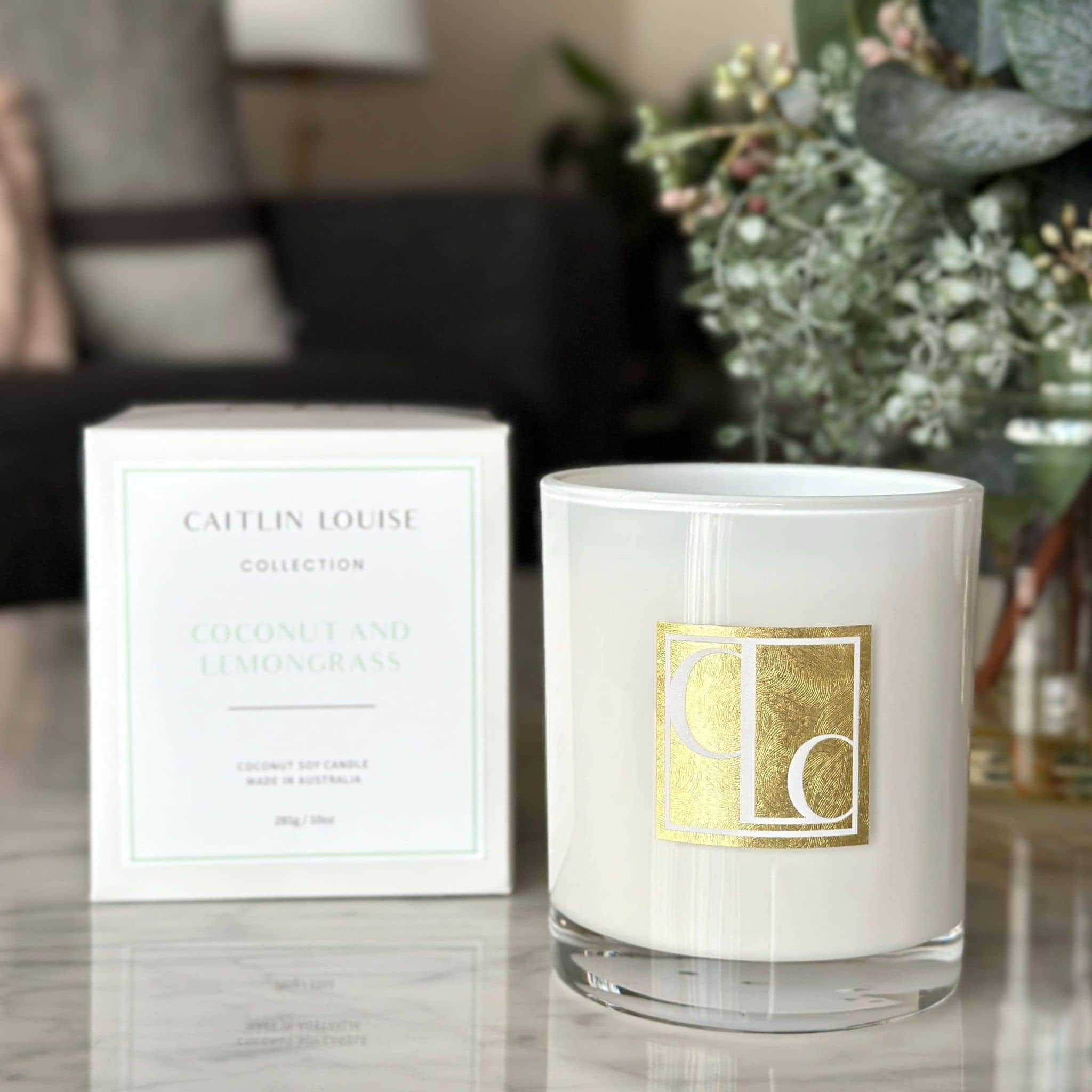 Caitlin Louise Collection Coconut and Lemongrass Scented Candle - on coffee table with box