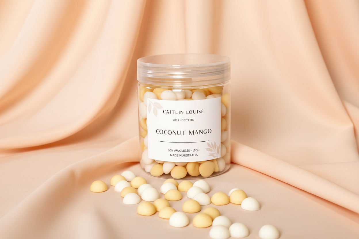 Caitlin Louise Collection's Coconut Mango handcrafted soy wax melt pebbles - white background, tan base.