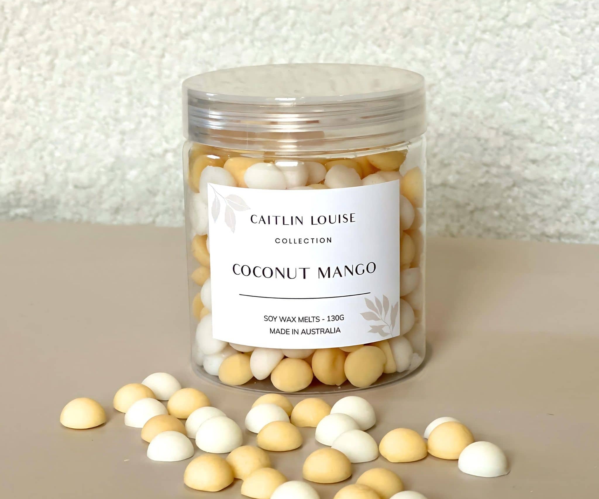 Caitlin Louise Collection's Coconut Mango handcrafted soy wax melt pebbles - white background, tan base.