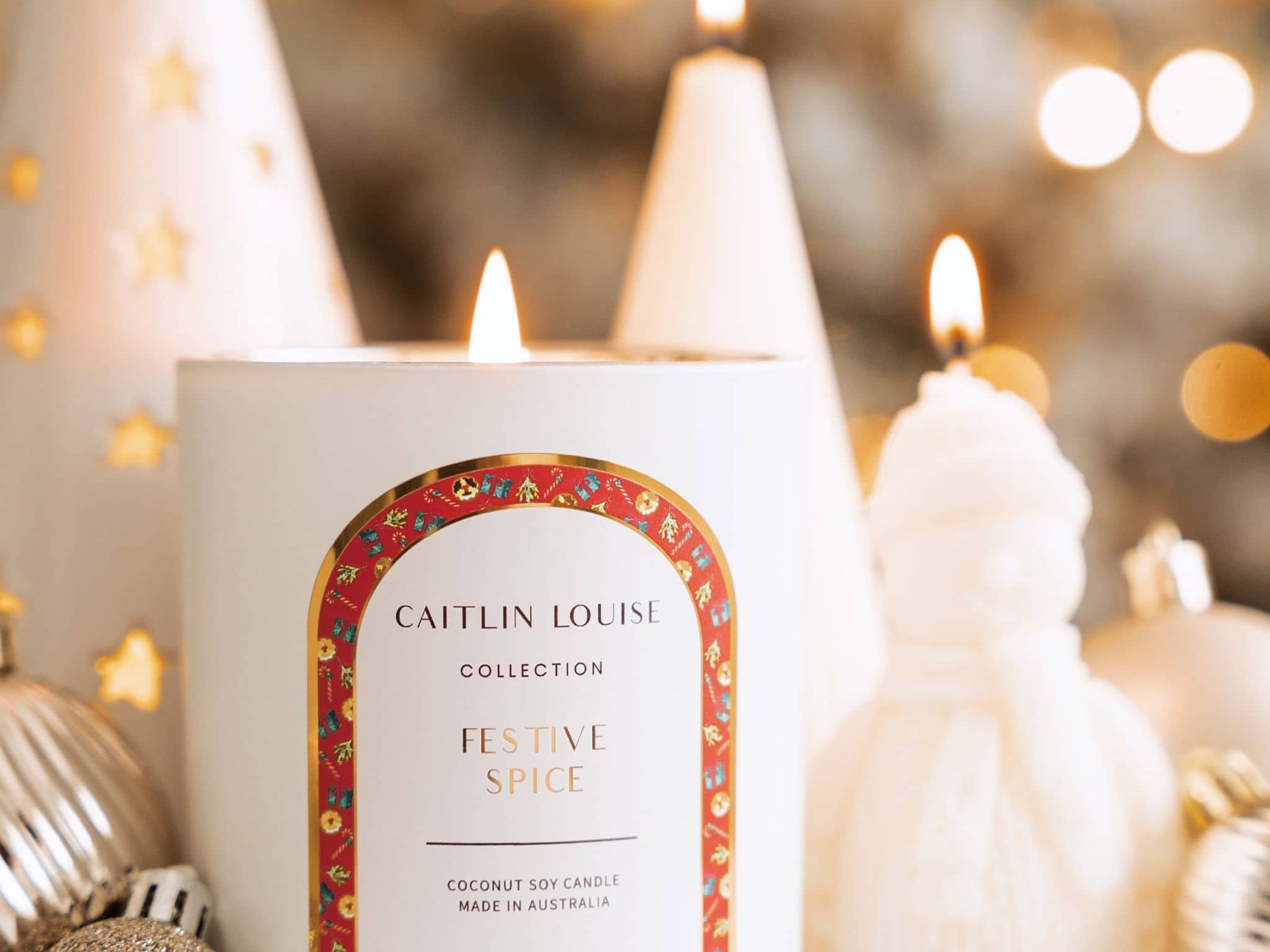 Caitlin Louise Collection Festive Spice Scented Christmas Candle - styled with Christmas baubles and sculptural candles.