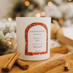 Caitlin Louise Collection Festive Spice Scented Christmas Candle - styled on brown board with cinnamon scrolls