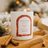 Caitlin Louise Collection Festive Spice Scented Christmas Candle - styled on brown board with cinnamon scrolls