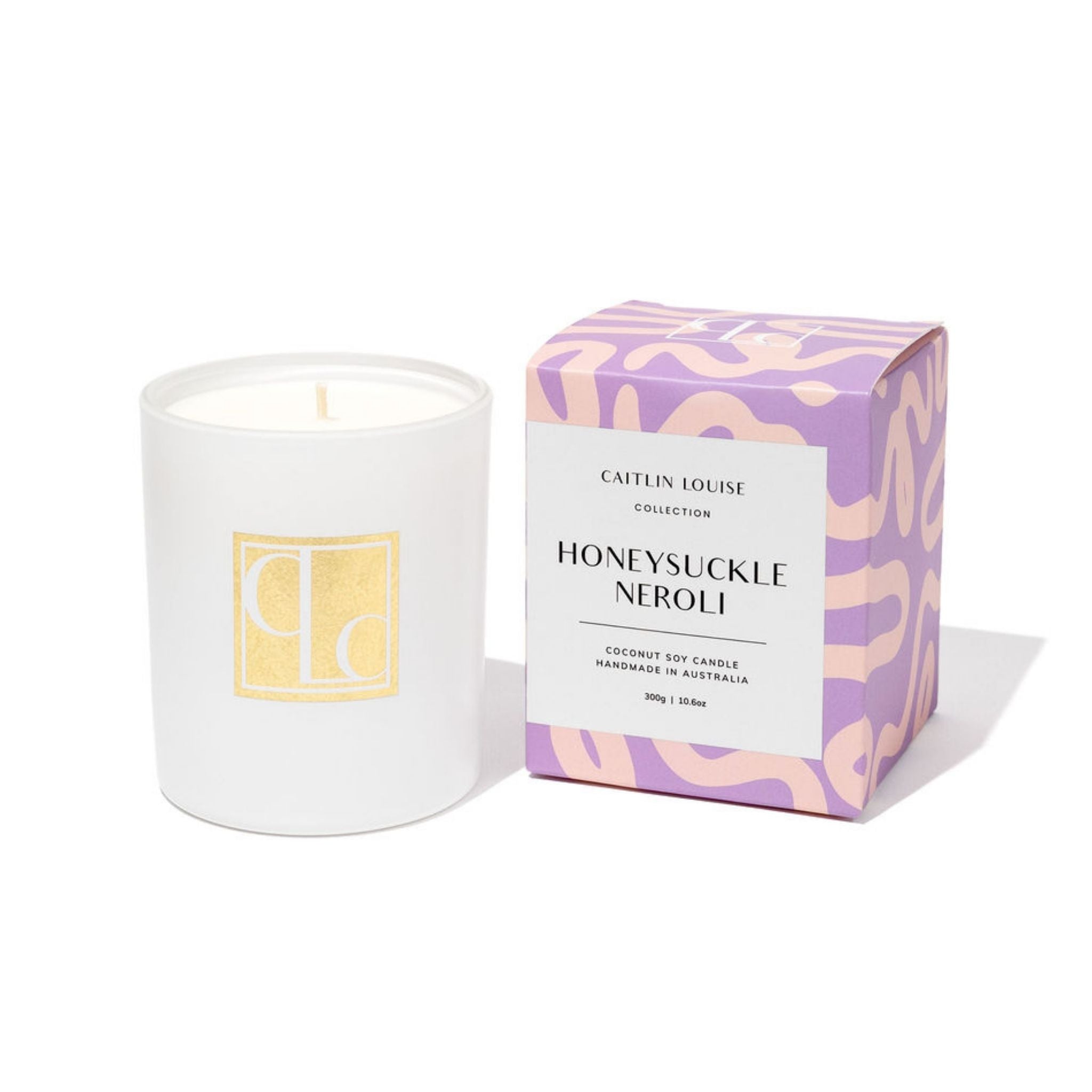 Caitlin Louise Collection candle with packaging labeled 'Honeysuckle Neroli' on a white background