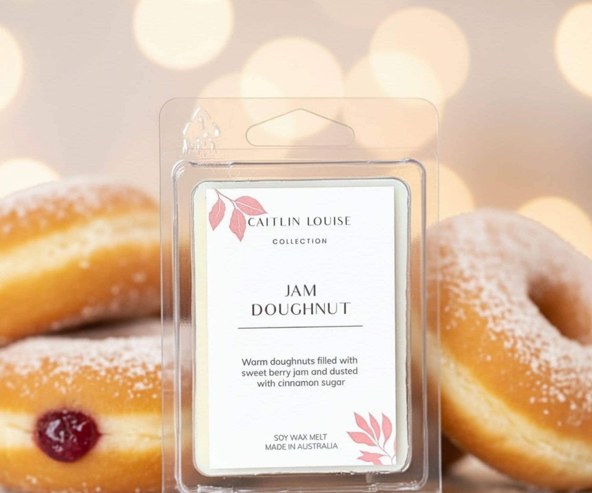 Caitlin Louise Collection Jam Doughnut scented wax melt with doughnuts in the background