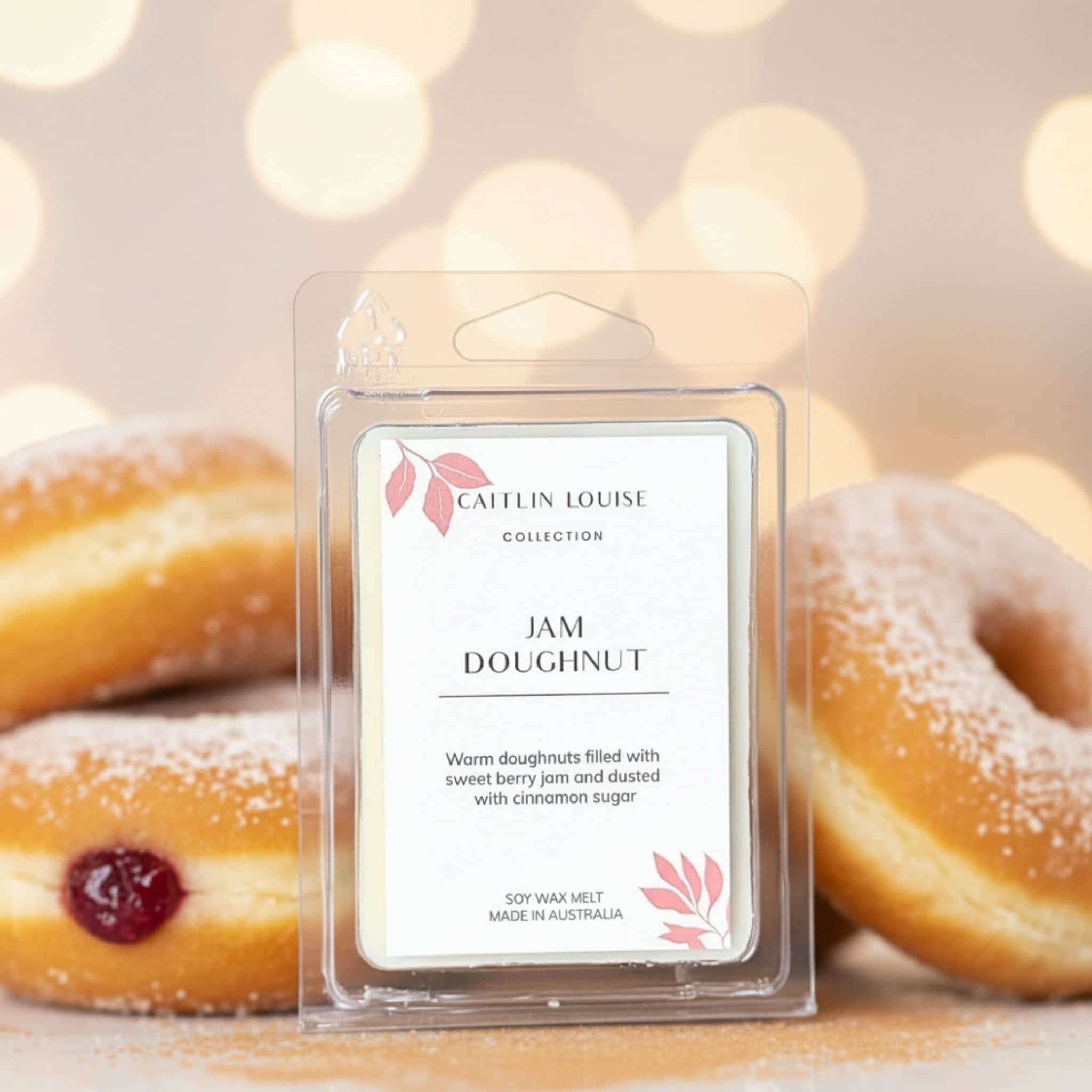 Caitlin Louise Collection Jam Doughnut scented wax melt with doughnuts in the background
