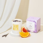 Amethyst crystal infused candle with decorative elements on a neutral background