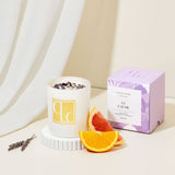 Amethyst crystal infused candle with decorative elements on a neutral background