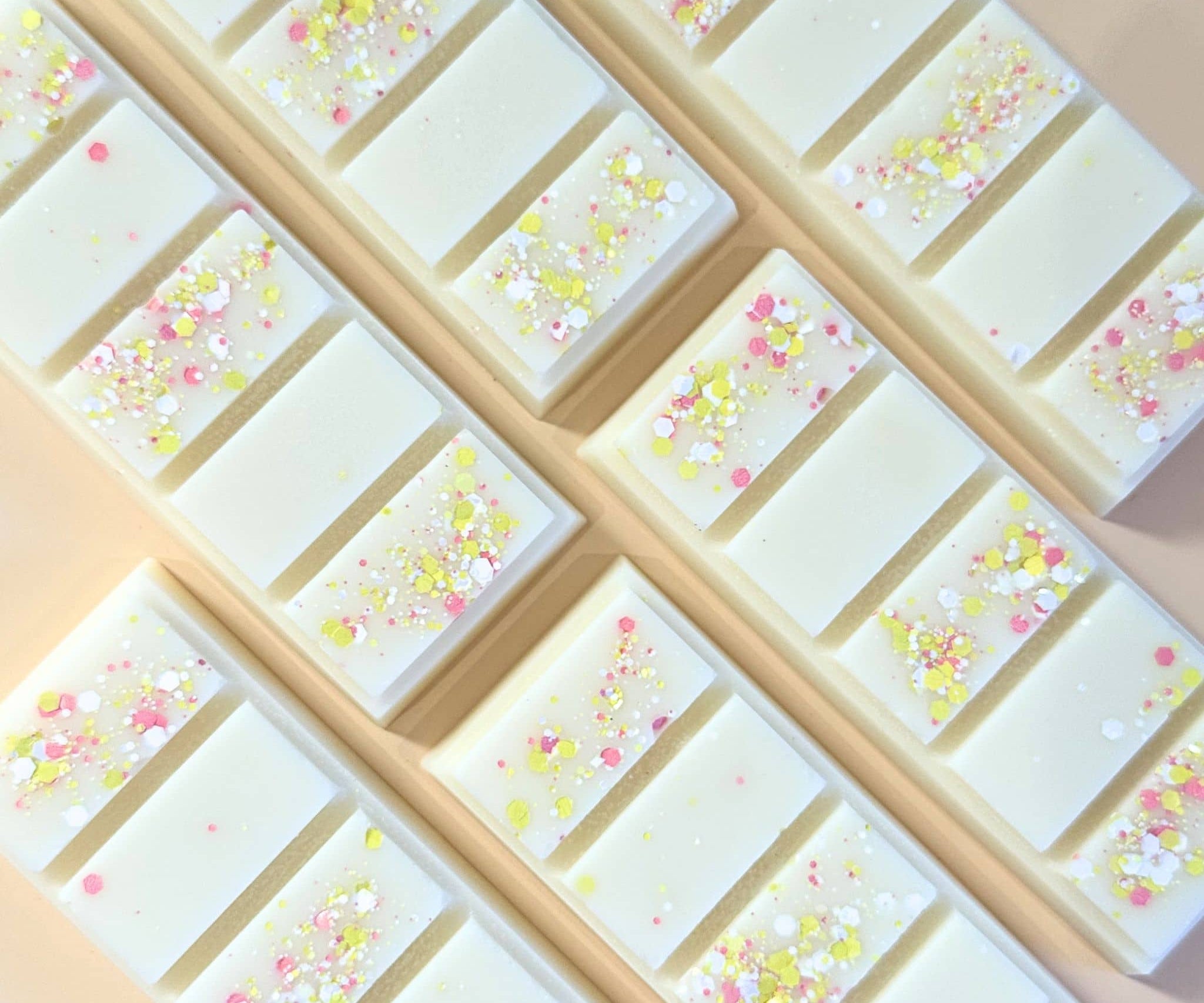 Lemon meringue scented wax melt snap bars flat lay on apricot coloured background